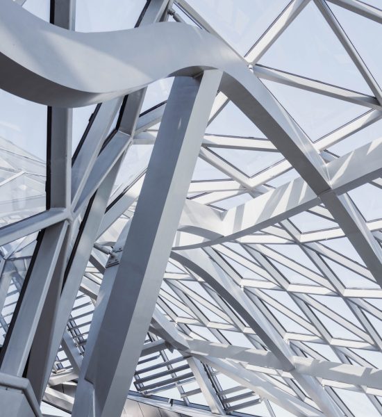 A vertical shot of the interior of a white geometrical building